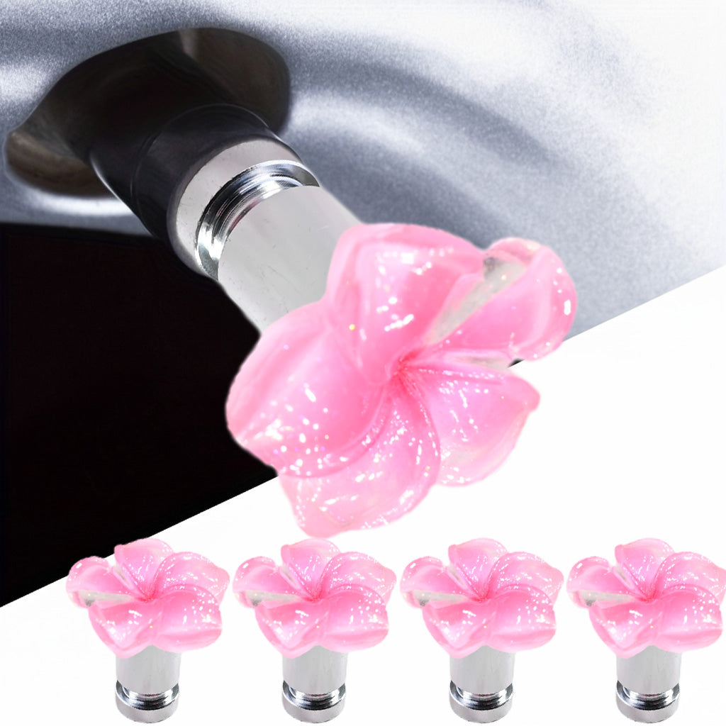 Pink plumeria flower valve stem caps 4-pack with car tire installation close-up – Xalvoria