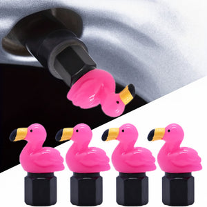 Xalvoria pink flamingo valve stem cap installed on a car tire valve, showing the bright flamingo topper and black metal base in detail.