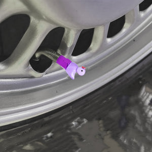 Xalvoria purple duck valve stem cap shown installed at an angled wheel position, highlighting the cute duck shape and glossy purple base.