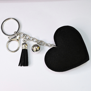 Xalvoria heart-shaped keychain back view with black faux suede finish and tassel charm