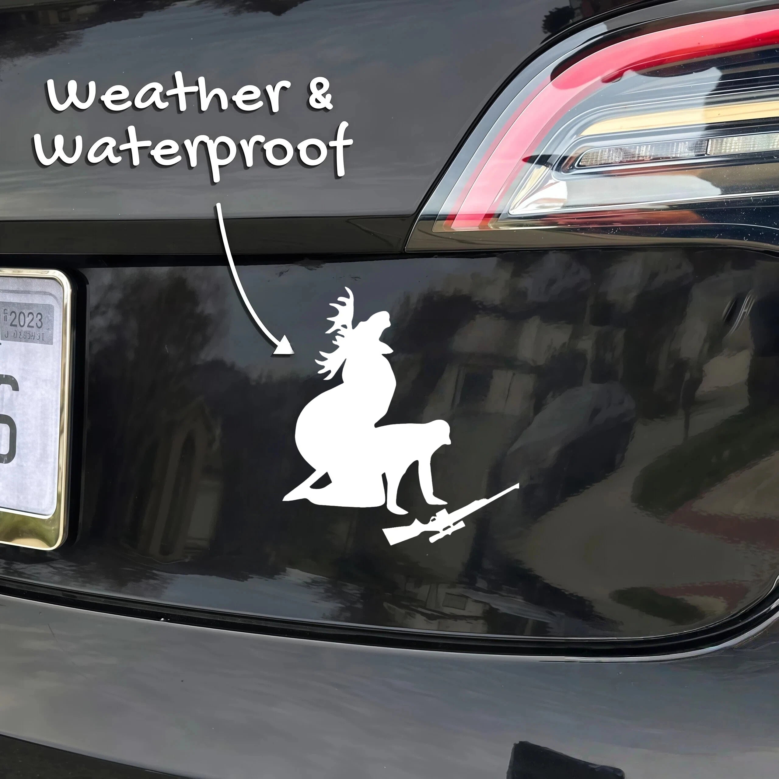 Xalvoria white hunting deer silhouette vinyl sticker with rifle applied on a car bumper, highlighting weatherproof and waterproof durability for outdoor vehicle use.