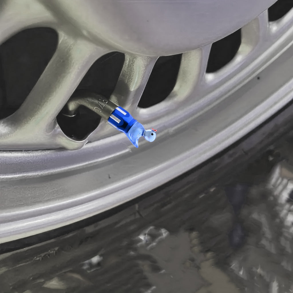 Close-up of a blue duck valve stem cap installed on a car wheel, resin topper with blue aluminum base.