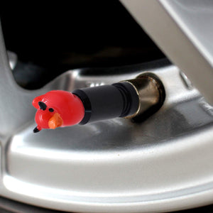 Close-up view of the devil duck valve stem cap installed on a car tire valve – Xalvoria