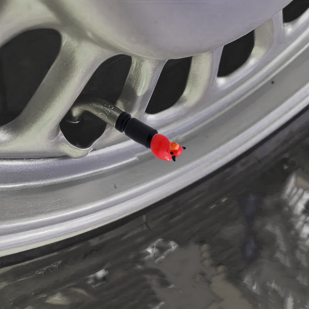 Devil duck valve stem cap installed on a car tire valve at an angled view – Xalvoria