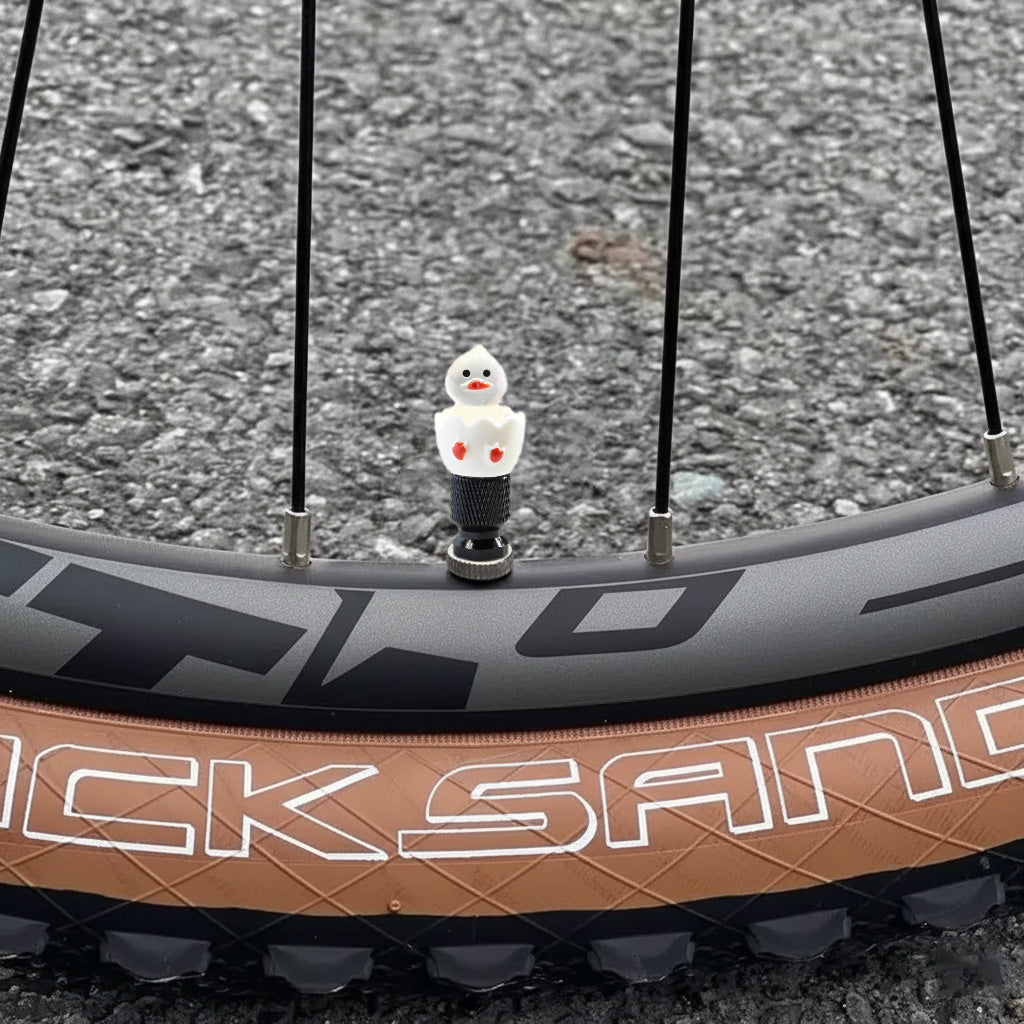 Hatching duck valve stem cap on a bicycle wheel outdoors – Xalvoria