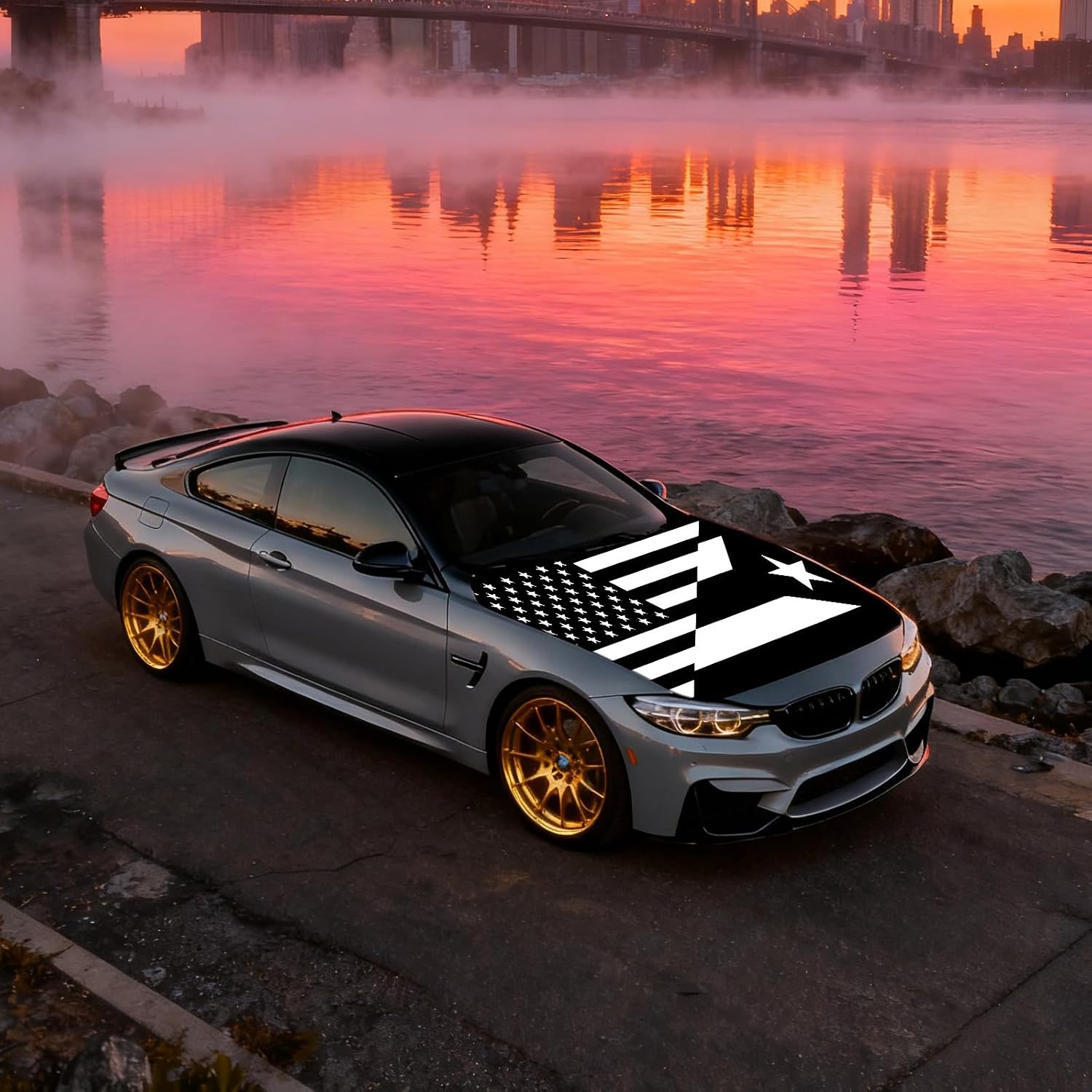 Xalvoria black and white USA Puerto Rico flag hood cover shown on a sports coupe beside the ocean at sunset