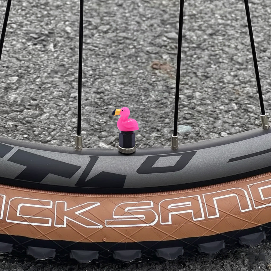 Xalvoria pink flamingo valve stem cap displayed on bicycle wheel valve stem with bright resin flamingo design