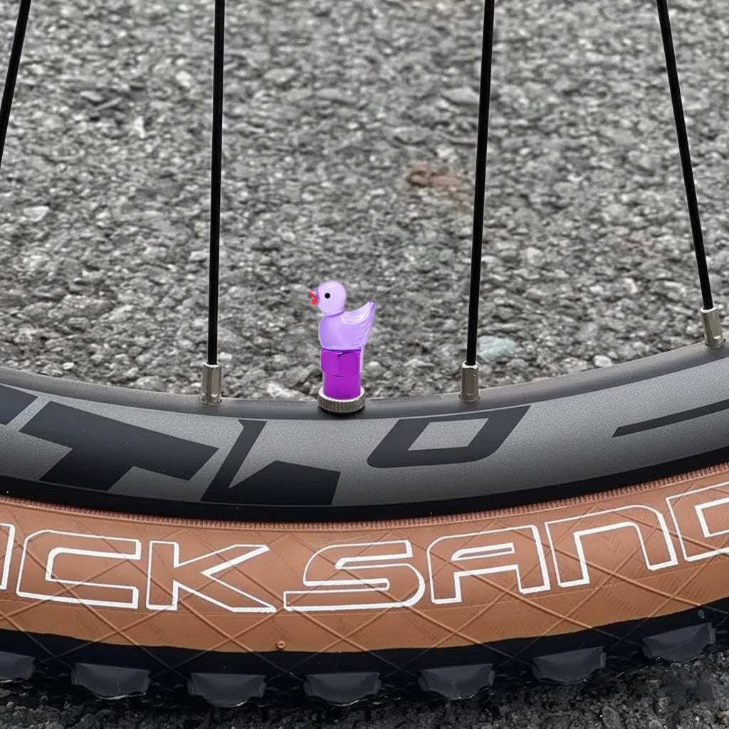 Xalvoria purple duck valve stem cap mounted on a bicycle wheel demonstrating fun and stylish tire decoration.