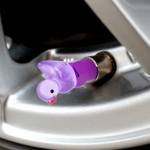 Xalvoria purple duck valve stem cap close-up installed on a car tire valve adding a cute decorative touch.