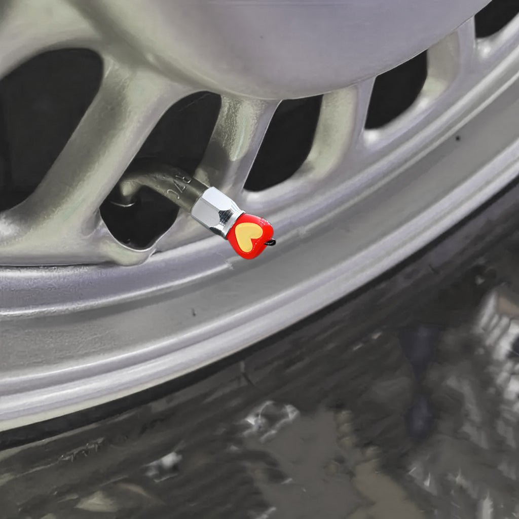 Xalvoria red Apple Core valve stem cap installed on a car rim adding a decorative apple accent to the wheel.