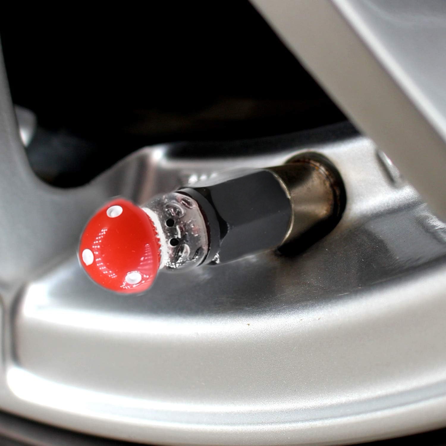 Xalvoria red Mushroom valve stem cap close-up view installed on vehicle wheel.