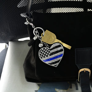 Xalvoria heart-shaped rhinestone keychain displayed on handbag inside car for lifestyle scene