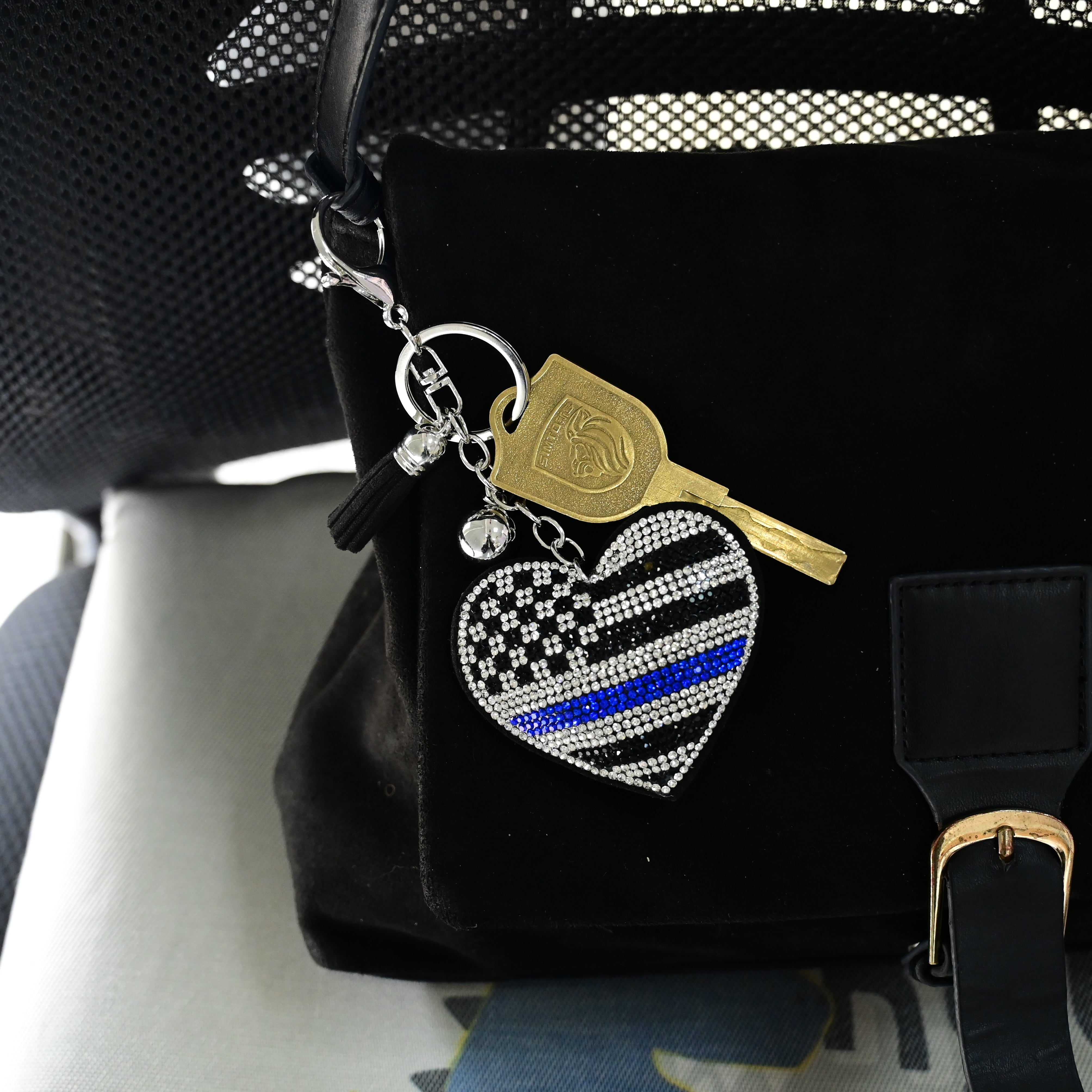 Xalvoria heart-shaped rhinestone keychain displayed on handbag inside car for lifestyle scene