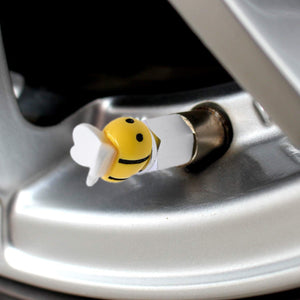 Xalvoria yellow bee valve stem cap shown in a close-up wheel installation scene for decorative and protective use.