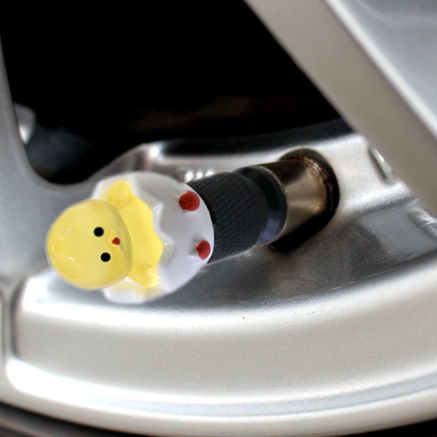 Xalvoria yellow hatching chick valve stem cap close-up installed on car wheel